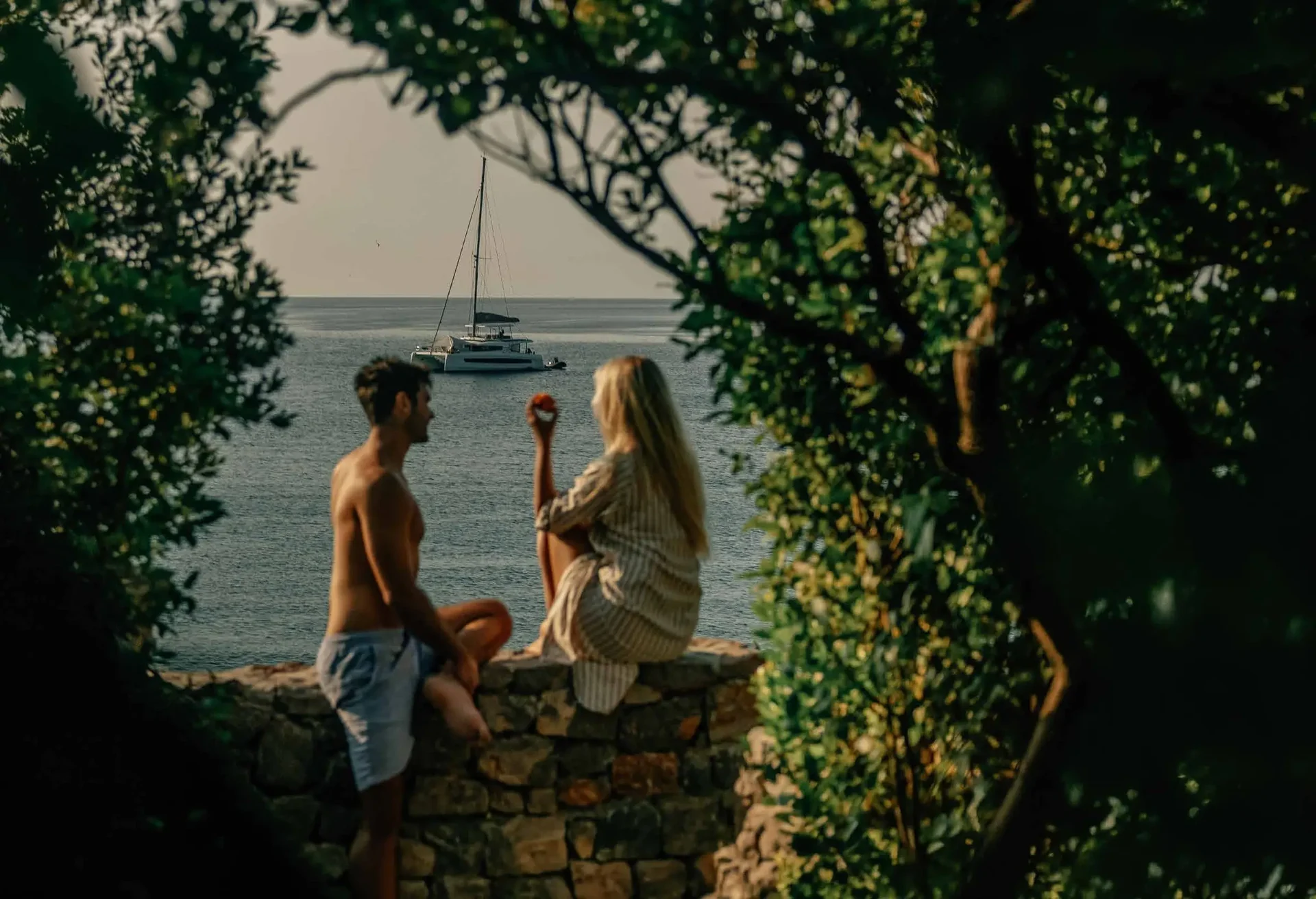 Couple by the sea under the trees